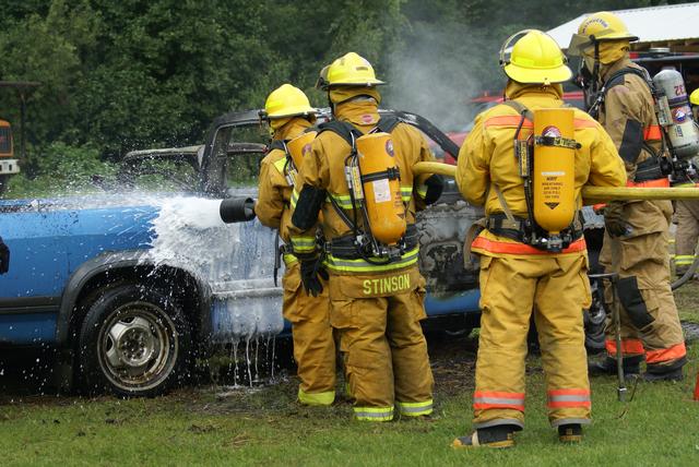 Garrett Krasher applies foam, backed up by Jim Stinson and Lewis VFD member Mike Flynn during vehicle fire drill in Keeseville NY on 8/21/2010